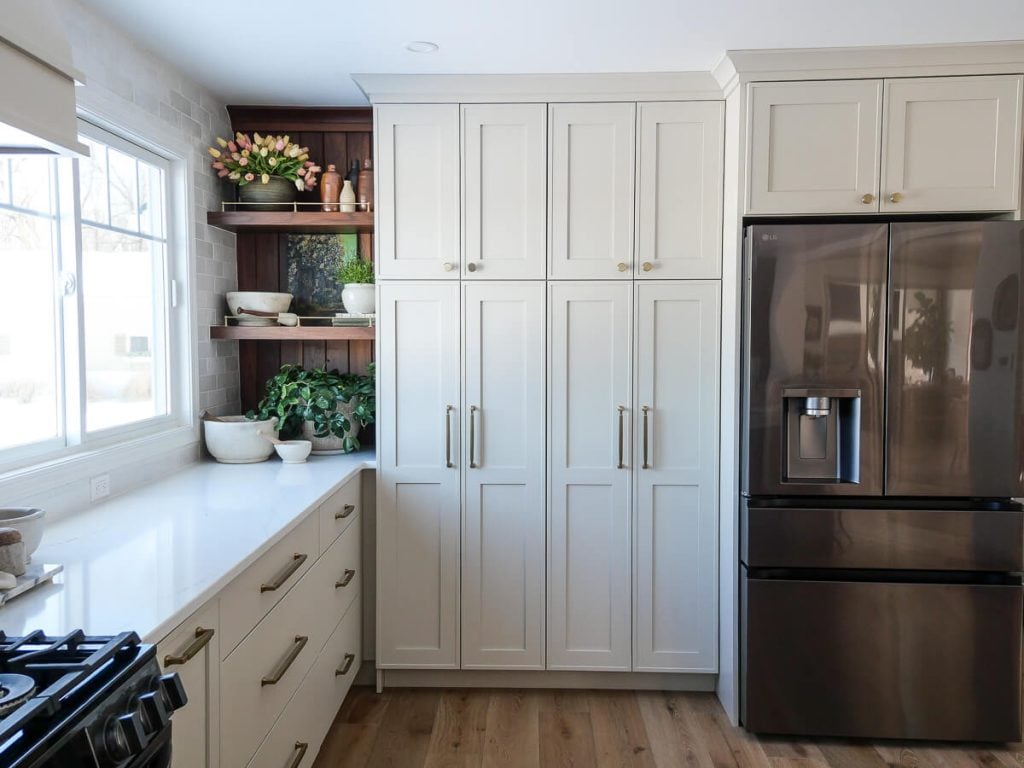 Large bank of cream colored kitchen cabinets.