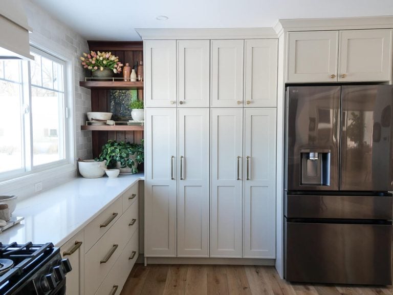Large bank of cream colored kitchen cabinets.