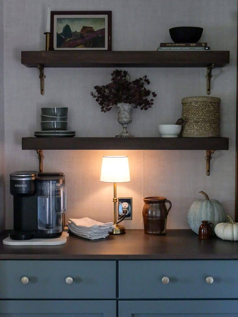 Warm glow with a lit lamp on a coffee bar.