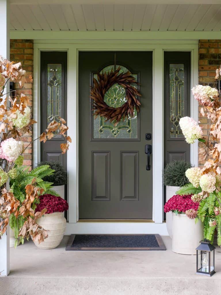 Fall front porch decorating ideas with dried branches.