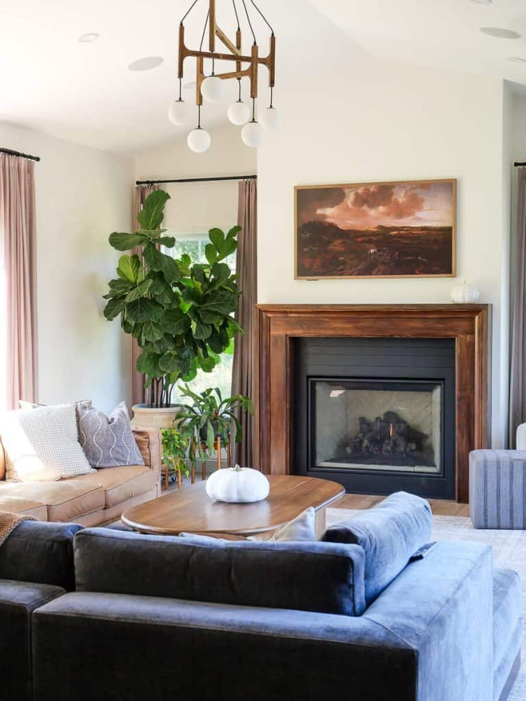 Wide angle shot of Living room with pumpkin on coffee table.