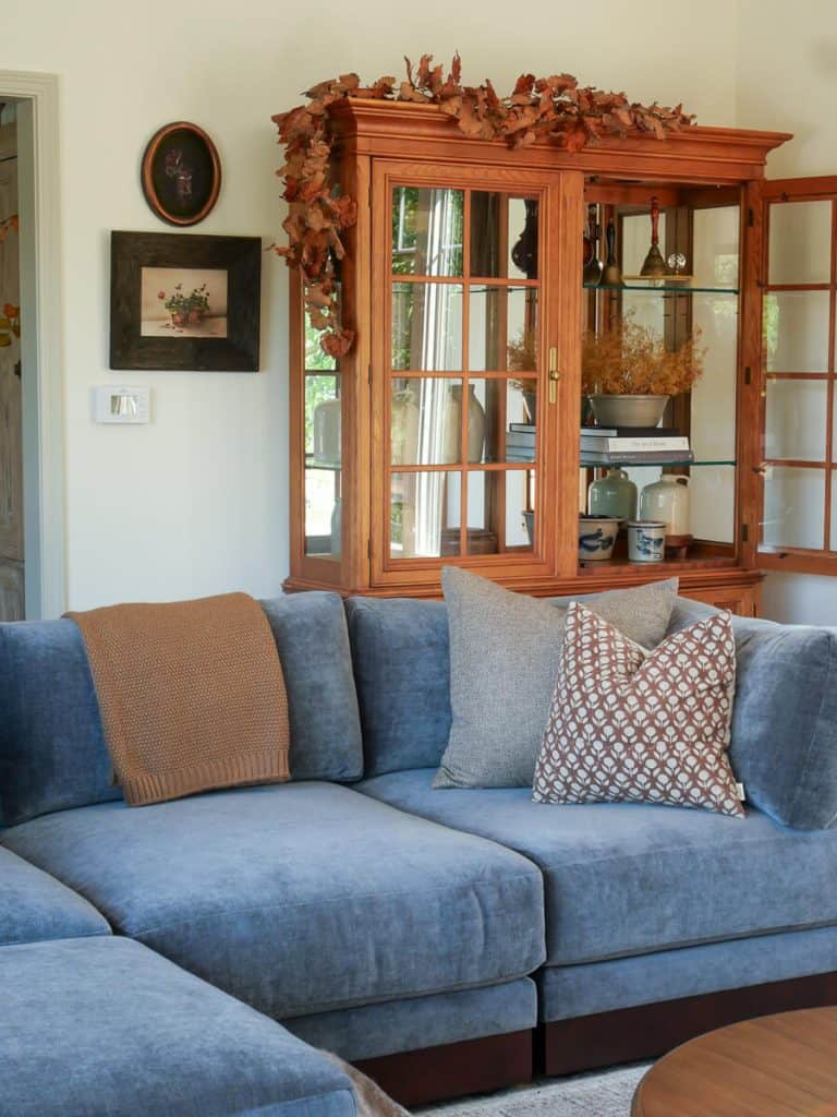 Fall pillows on a blue sofa.