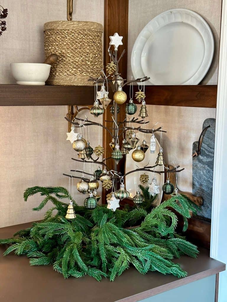 Mini ornament tree with garlands around the base.