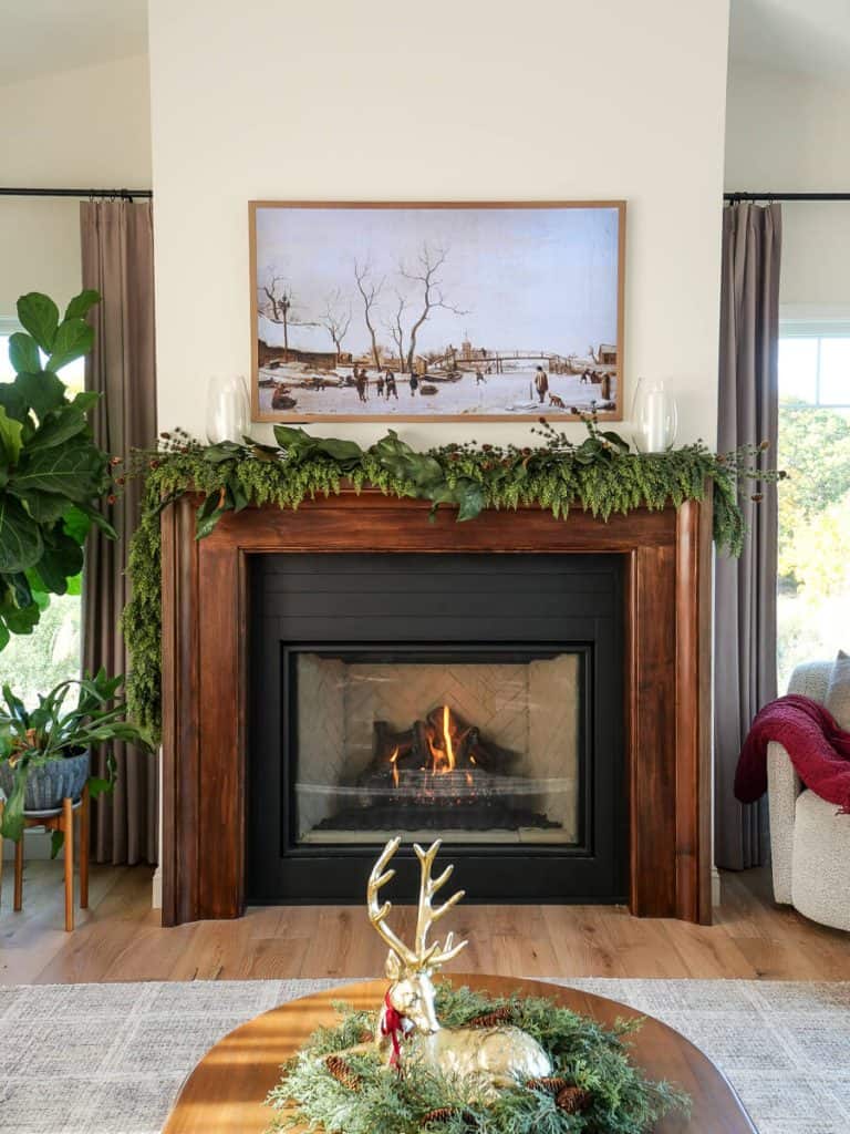 Fireplace mantel decorated for winter.