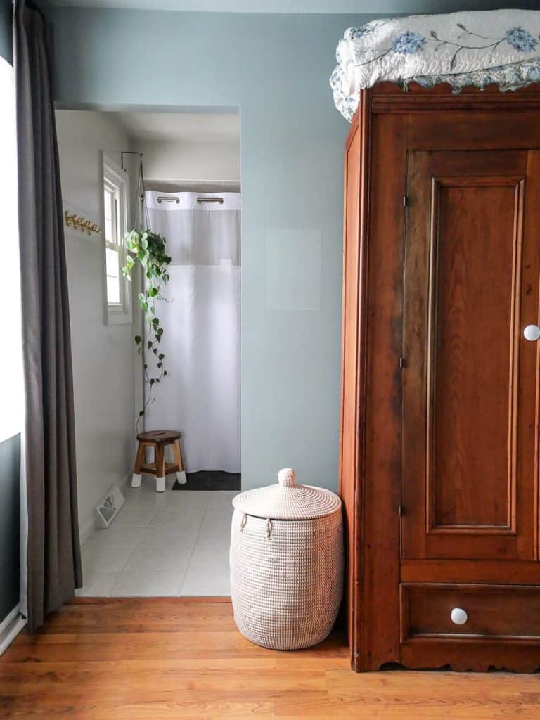 Night train paint color on bedroom walls with an antique cabinet.