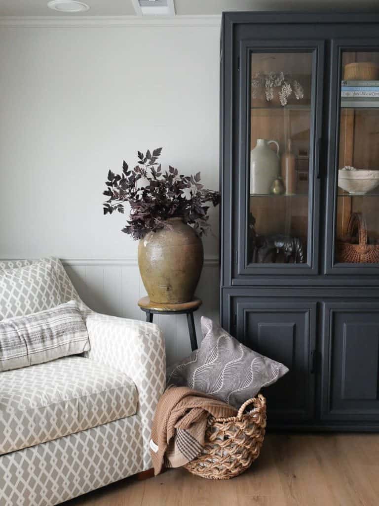 Oversized chair with styled cabinet.