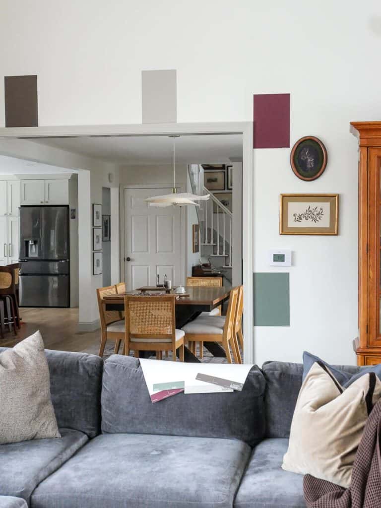 Sampling paint samples on the wall in a living room.