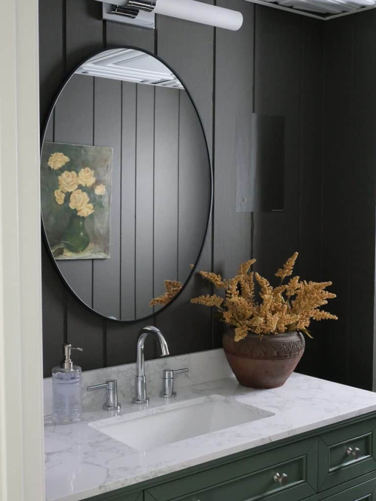 Bathroom vanity with dark brown paneling.
