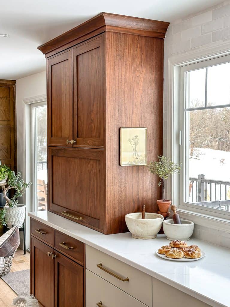 Pulled back shot of a kitchen with food on the counter.