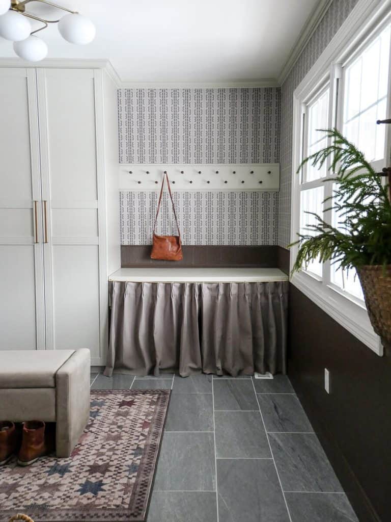 Mudroom with hooks and a leather amazon find purse.