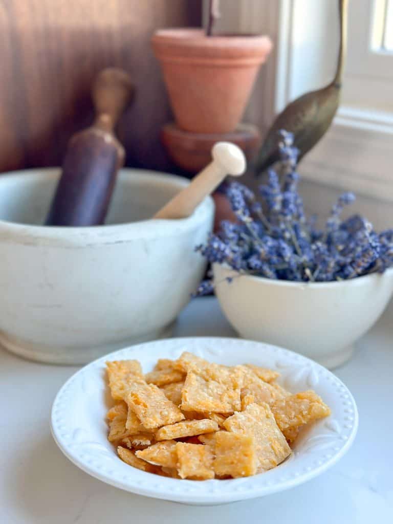 Crunchy cheese crackers on a countertop with decor.