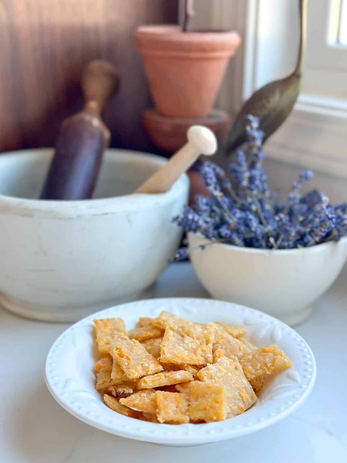 Crunchy cheese crackers on a countertop with decor.
