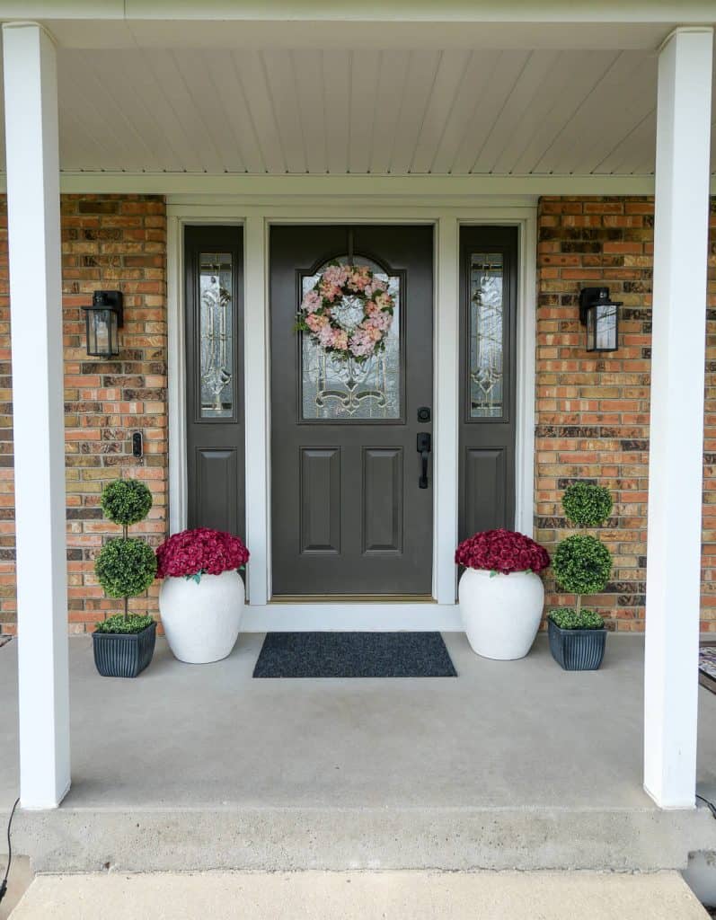 Symmetrical planters on front porch.