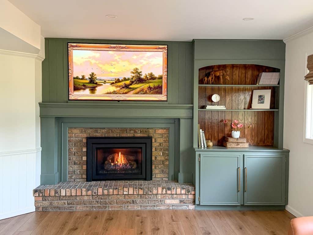 Modernized 1970s brick fireplace styled with open shelving.