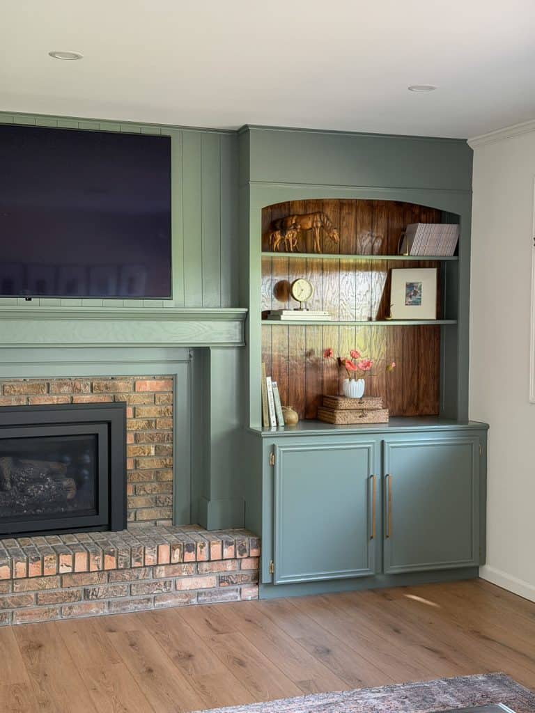 brick fireplace mantel with a new wood surround.