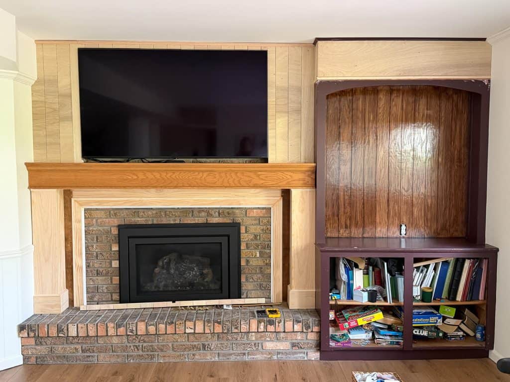 Fireplace trimmed out in wood.
