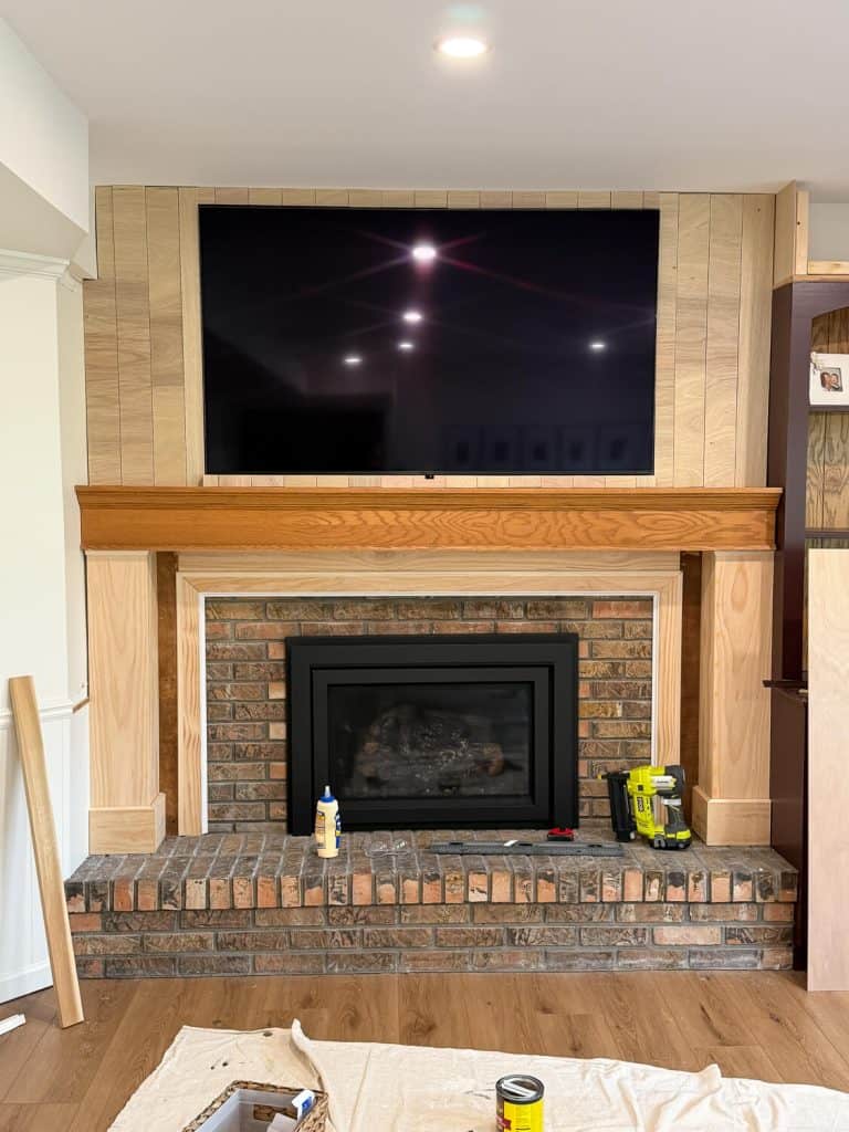 Adding shiplap to a brick fireplace.
