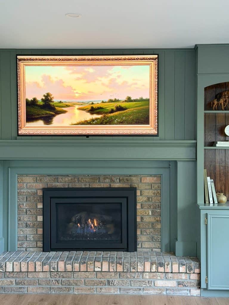 Green mantel surround on a family room fireplace.