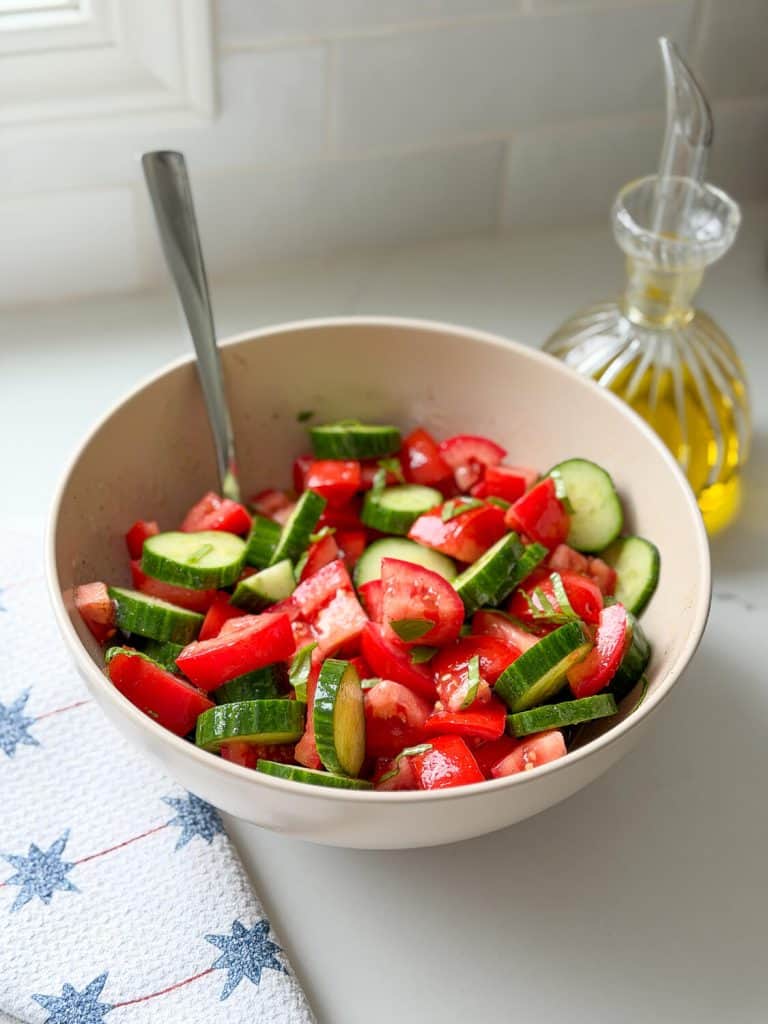 Bowl of marinated tomatoes and cucumbers.