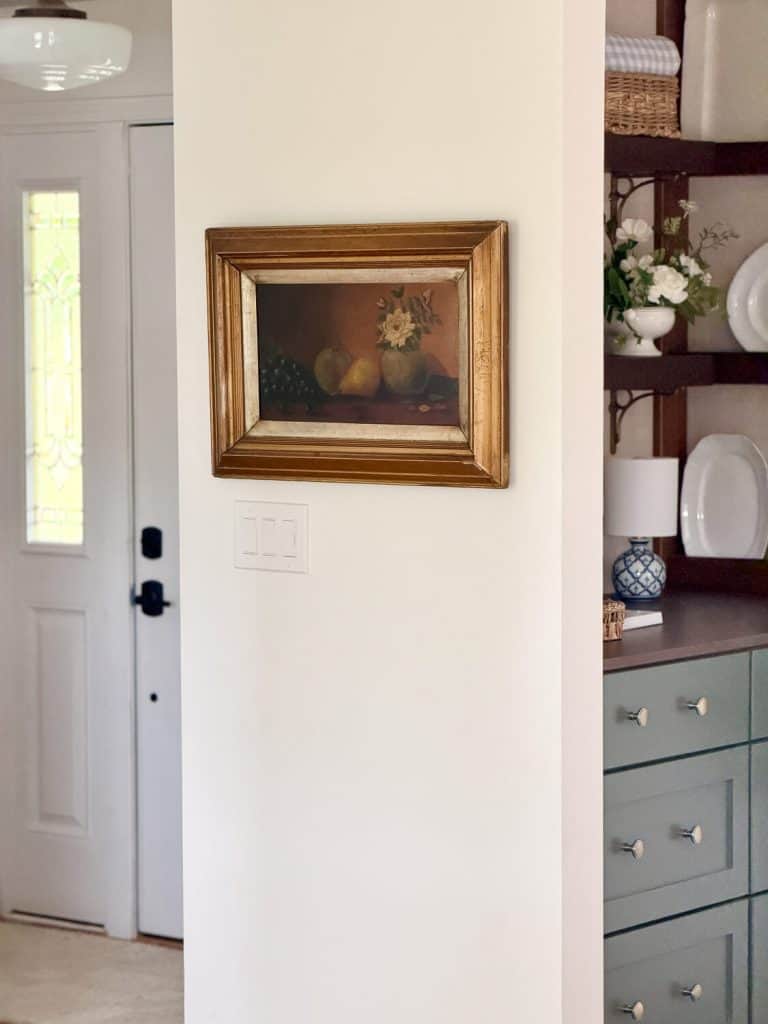 Antique artwork on a blank wall.